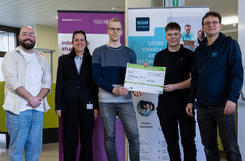 Group photo of winning project holding cheque