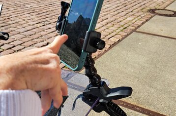 A holder with smartphone on a wheelchair