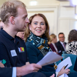 Minister in the first row of the public