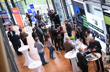 Symbolic photo - aerial view of people on a exhibition stand
