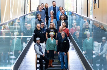 Group of people in the stairs of the media building