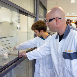 Ein Schüler zündet im Gefahrstofflabor unter Aufsicht einen Versuch 