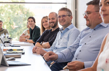 A group of people sitting around a table