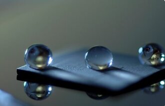 Drops of water lying on a microscope slide 