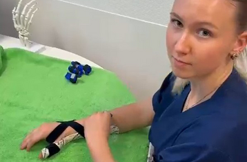 Woman demonstrating removal of finger splint