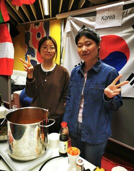 Symboldbild: Der koreanische Stand mit zwei Studentinnen und Flagge 