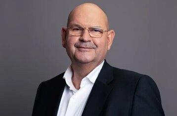 One sees an older man in a suit