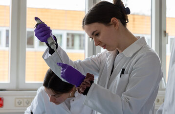 Photo of woman in lab during experiment